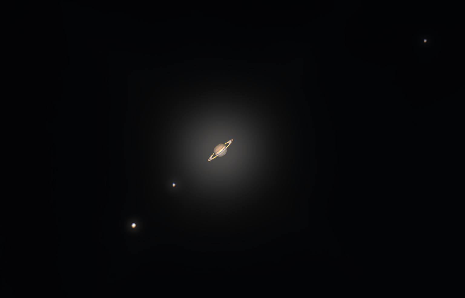 Saturn and its 3 biggest moons through my 8 inch telescope. I tried to edit this picture to show you spectacular Saturn appears looking through the eyepiece of the telescope