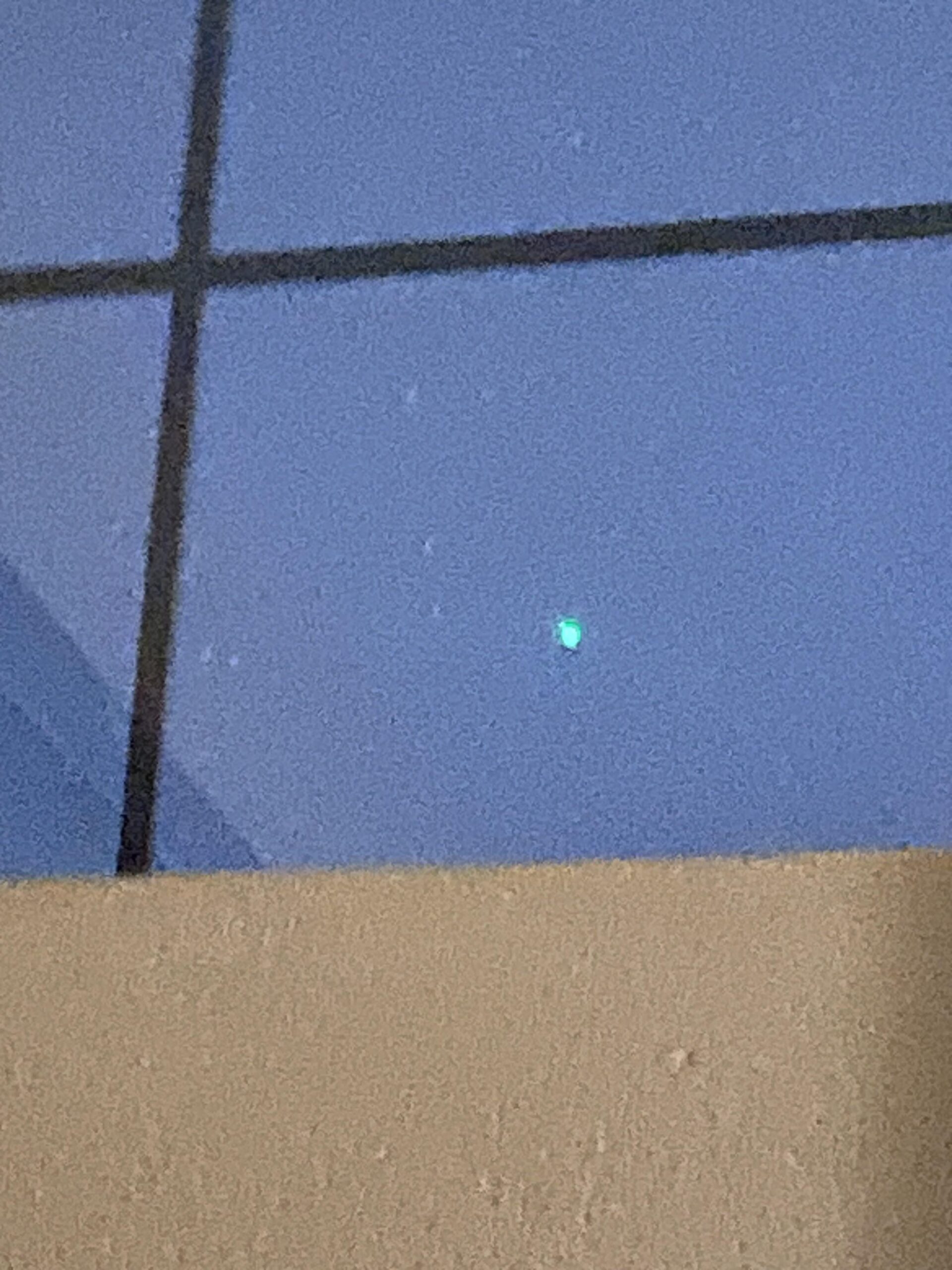 Green light hovering, flying, hovering again over Las Vegas after loud