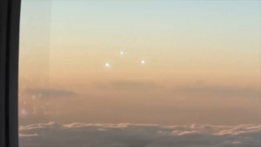A video from 2013 capturing mysterious orbs of energy arranged in a triangle formation, filmed from a plane window.