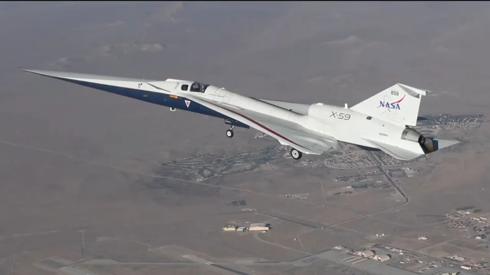  A small white plane flies above the desert. 
