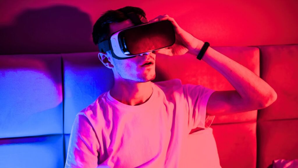 Are we living in a simulation? Physics says no. Are we living in a simulation: a man in VR goggles sits on a couch, red and blue lighting. Photo: Frimufilms / Freepik