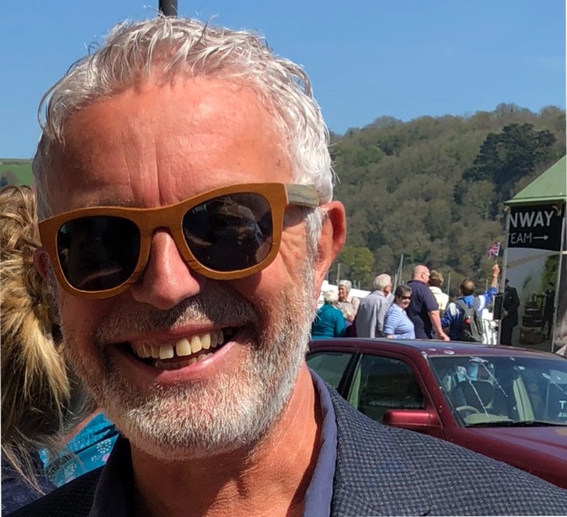 Simon Burton wearing sunglasses and smiling.