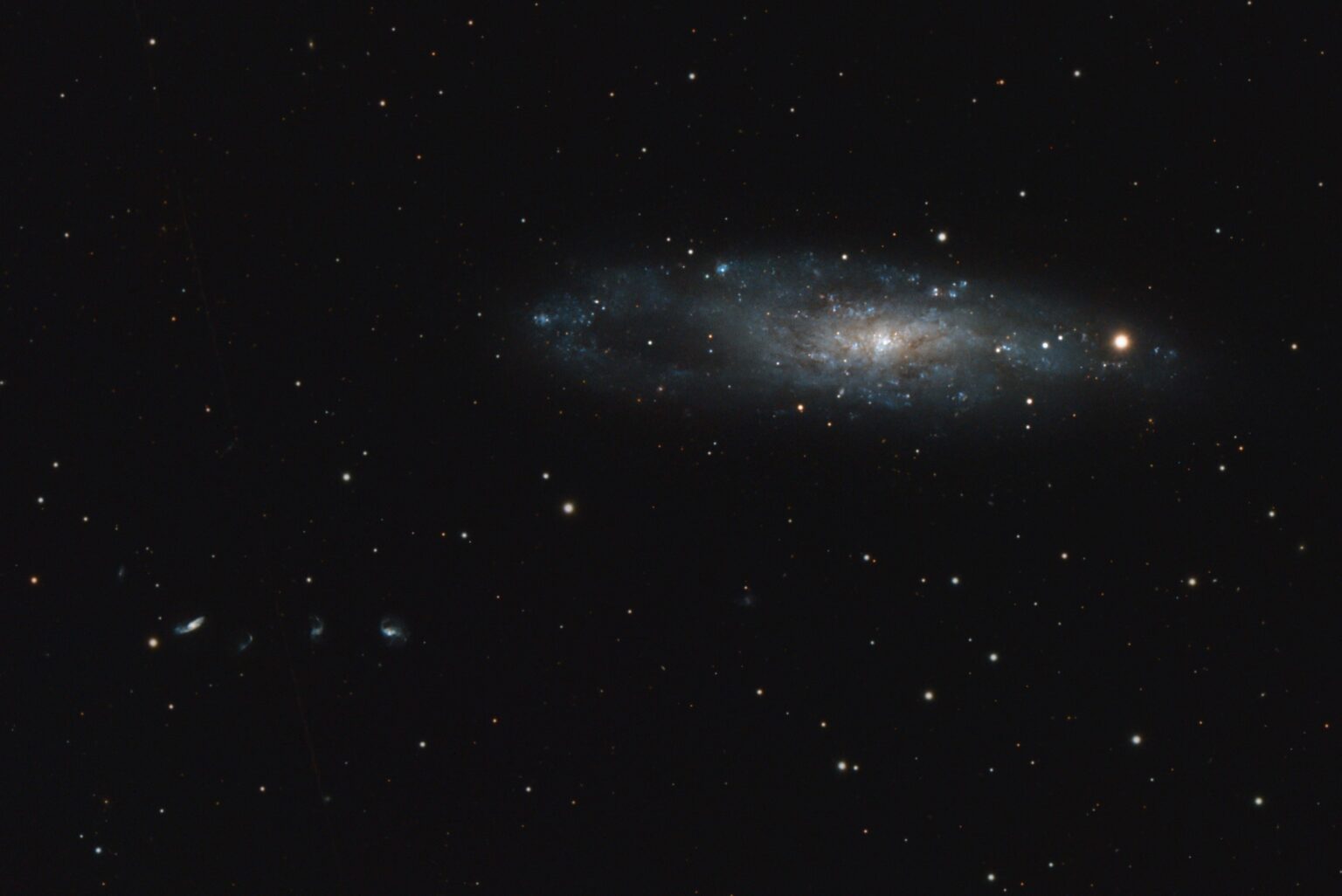 NGC 247 w/a string of galaxies