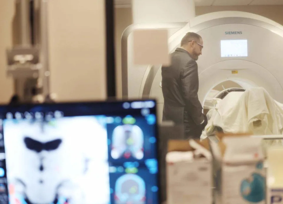 Neurosurgeon Dr. Charles Munyon talks to patient Catherine Klie from a machine Monday during an incisionless brain procedure at Novant Health Mint Hill Medical Center.