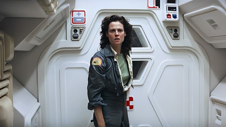 Ripley stands by the airlock