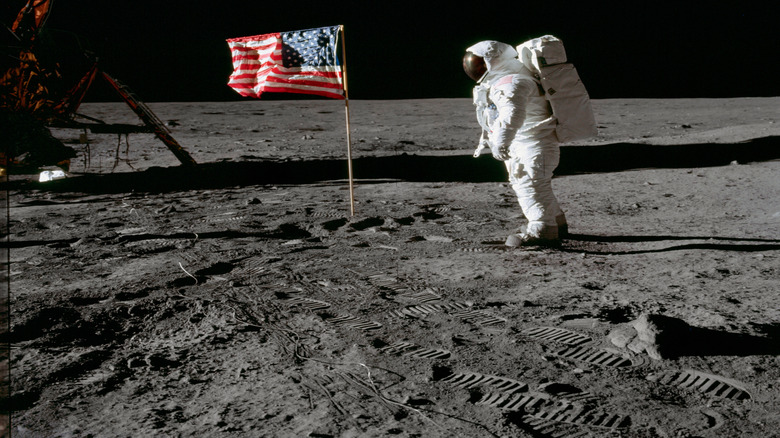 Buzz Aldrin on the lunar surface next to the American flag