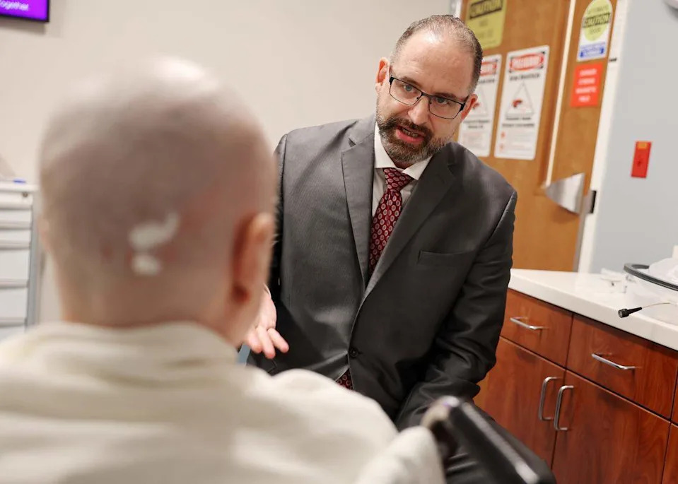Neurosurgeon Dr. Charles Munyon talks to patient Catherine Klie Monday before she undergoes an incisionless brain procedure at Novant Health Mint Hill Medical Center.