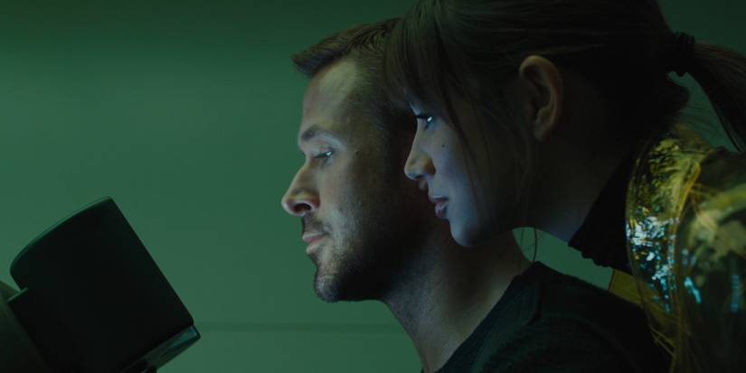 Blade Runner 2049's Officer K With the Ghost of a Smirk as He Sorts Through Files With Joi
