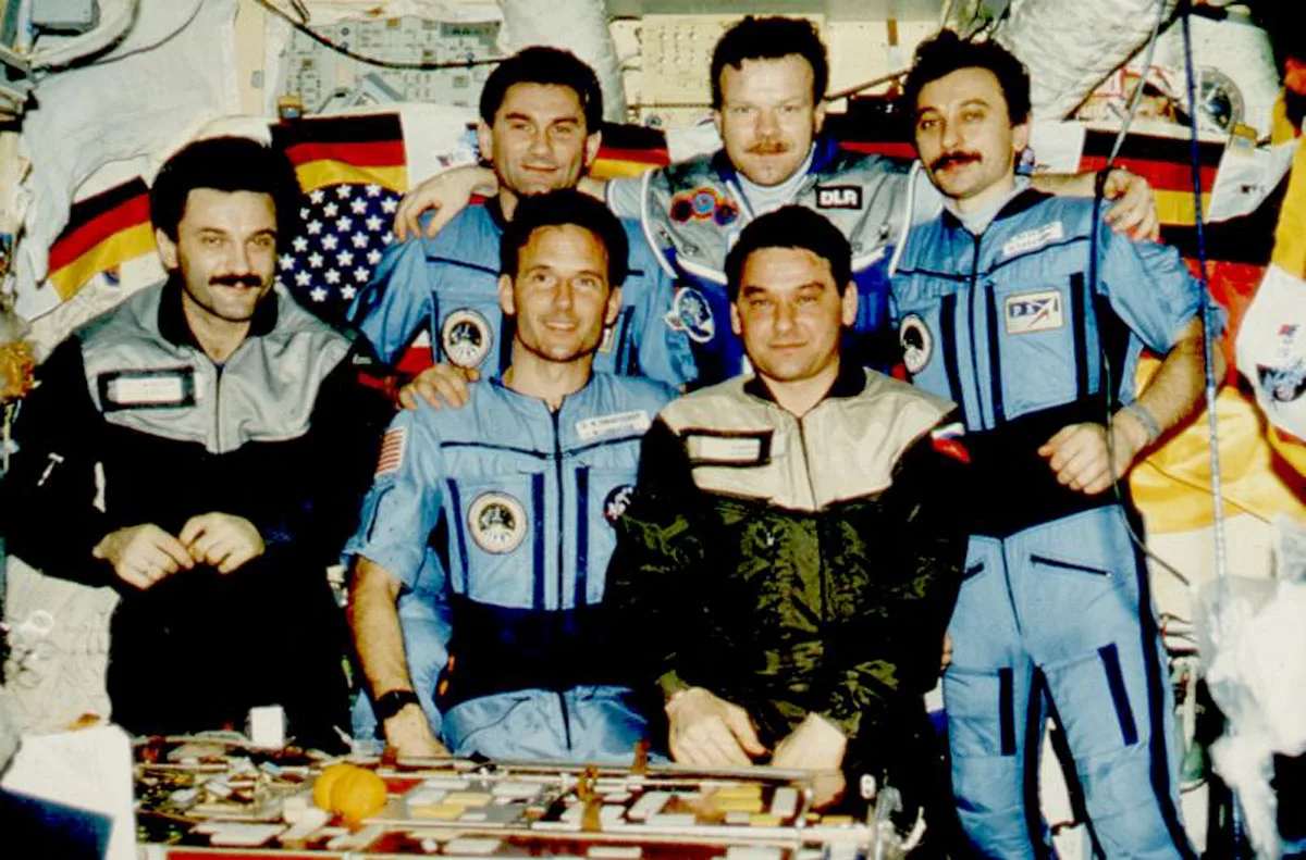 Old photo of six people aboard Mir space station.