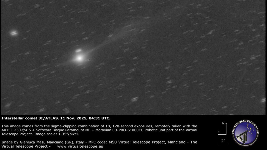 a grayscale image showing a white dot of 3I/ATLAS with a long white tail behind it.