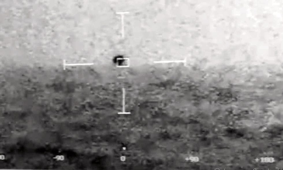 thermal image showing a dark object with a target reticle