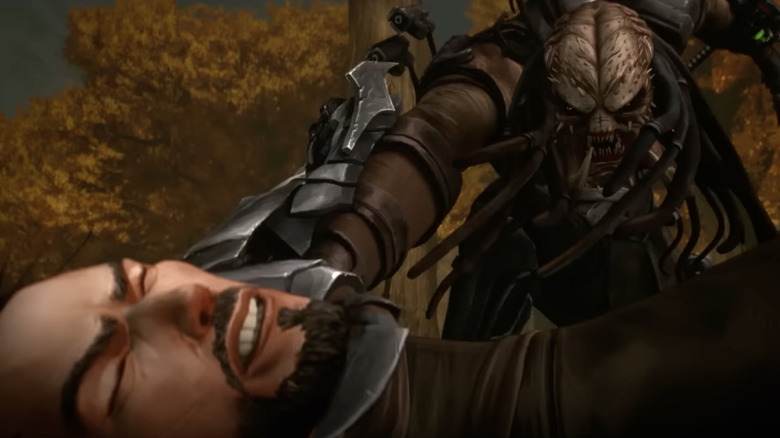 A predator grabs Kenji by the neck in Predator: Killer of Killers