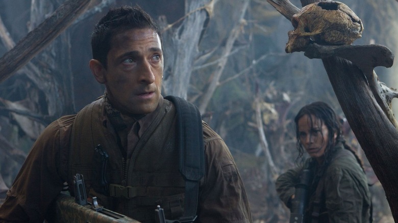Royce and Isabelle walk through an alien jungle in Predators