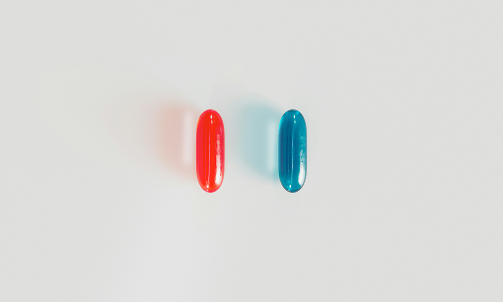 A red and blue pill sit side by side.