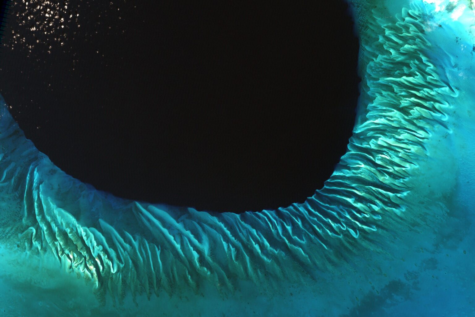 Satellite image of the sands and seaweed in the Bahamas. The image was taken by the Enhanced Thematic Mapper plus (ETM+) instrument aboard the Landsat 7 satellite. Tides and ocean currents in the Bahamas sculpted the sand and seaweed beds into these multicolored, fluted patterns.