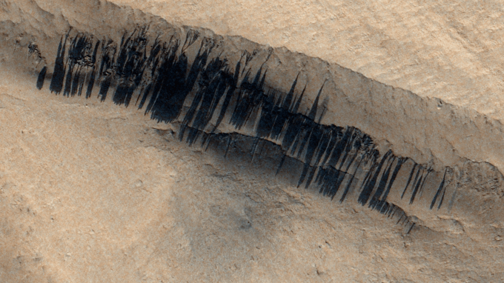 When a meteoroid struck Mars, it triggered ~100 dust avalanches down an ancient volcano's slopes. The European Space Agency’s ExoMars Trace Gas Orbiter captured these dust avalanches on the slopes the night before Christmas in 2023.