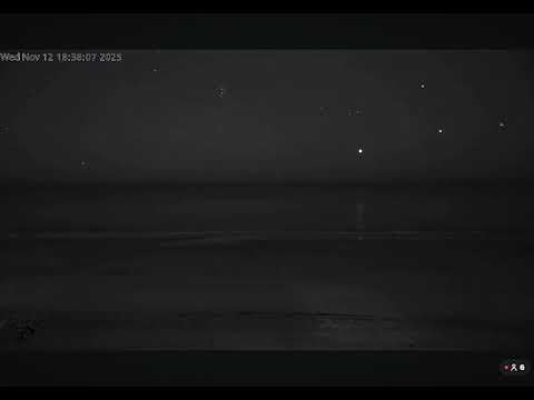 3 orbs appear out of nowhere and move in unison whilst lighting up the ocean, and flashes