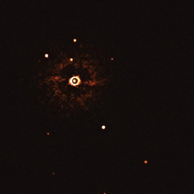 A real image of a very young (17 million years old) star system only 300 light years away. The protoplanetary disk is visible.