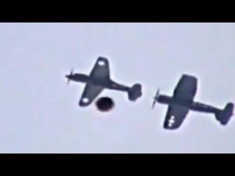 video footage of a UFO passing by planes at an air show in the UK. No time or date information is available.