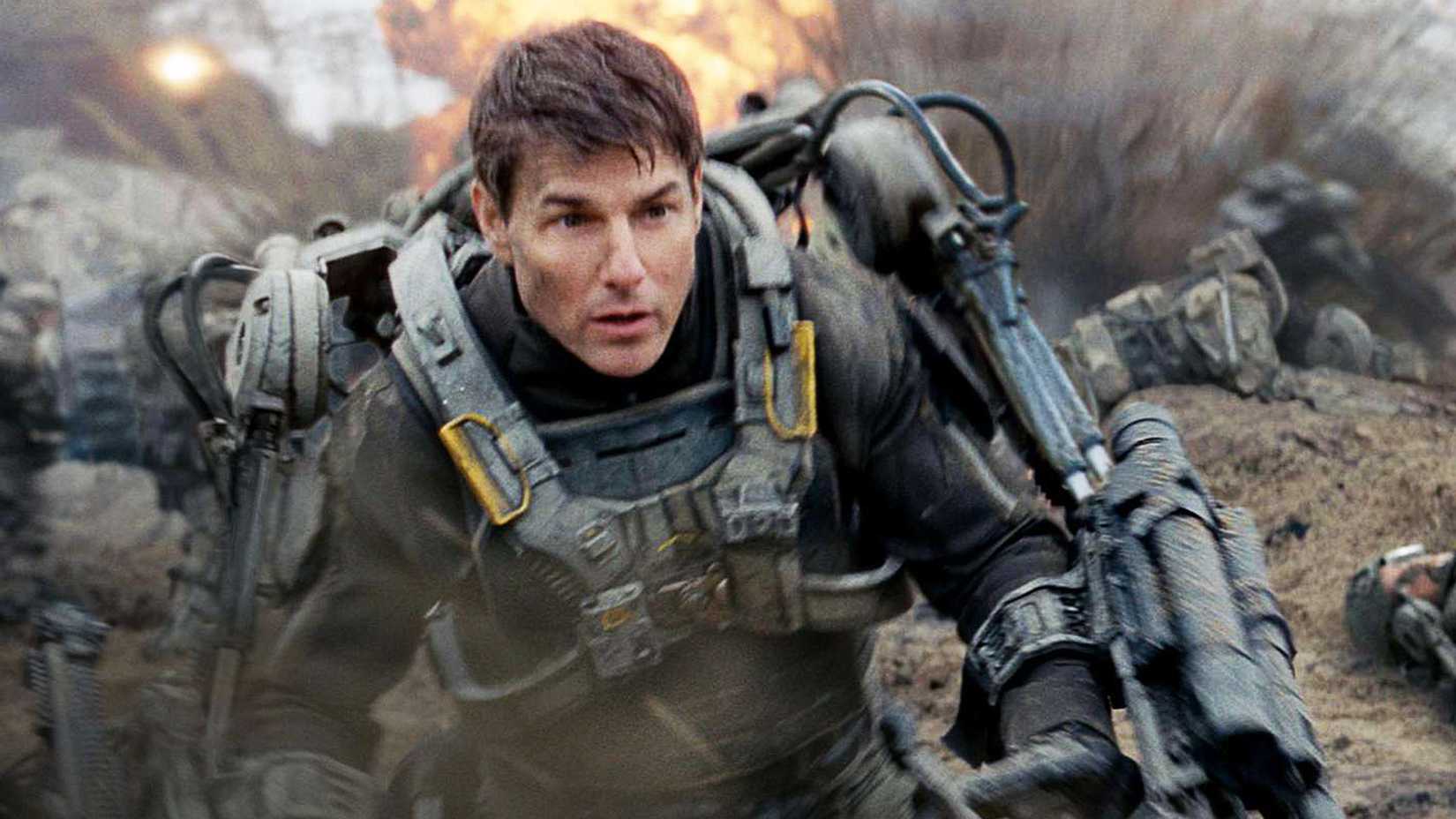 Tom Cruise runs across a battlefield in Edge of Tomorrow