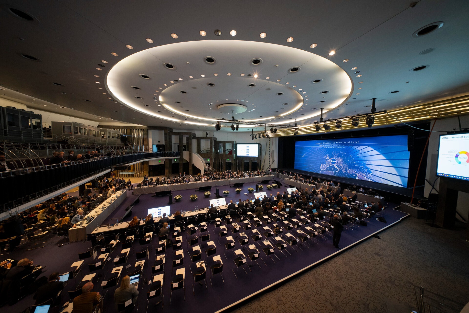 A view of an empty conference room with a large circular light overhead
