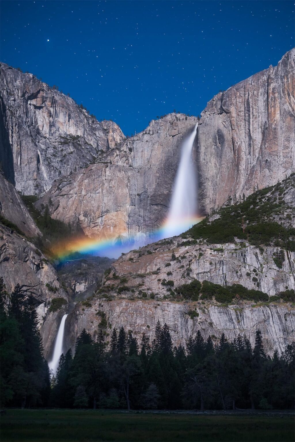 Moonbow (lunar rainbow) over the base of Yosemite Falls in California