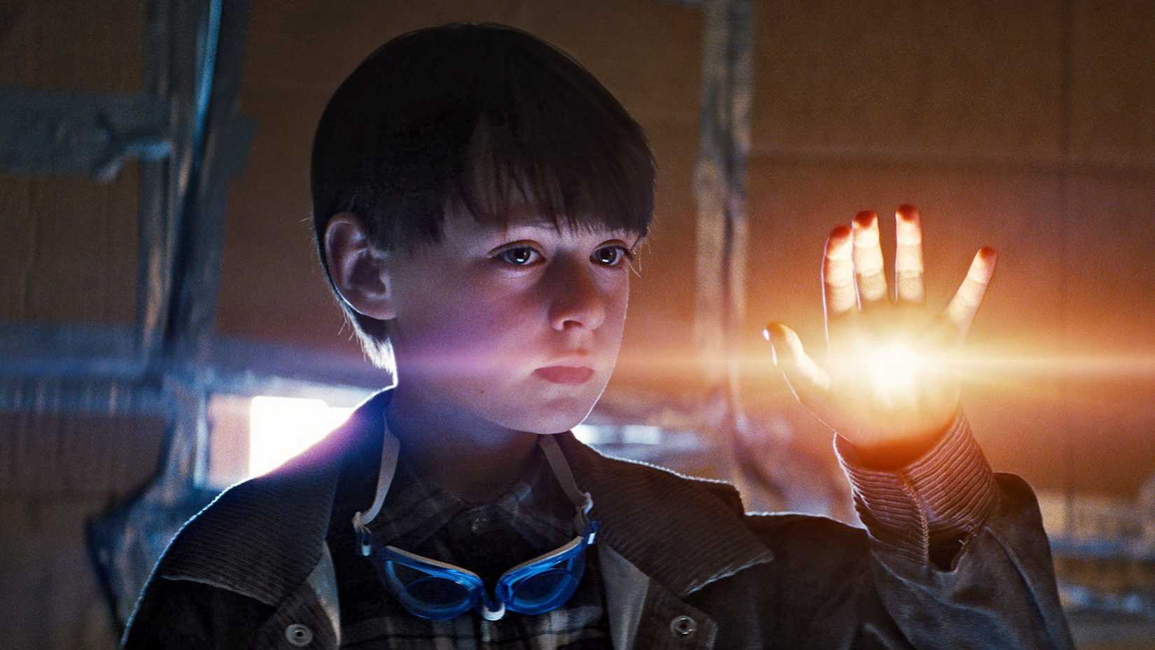 A kid with a glowing hand looks on in Midnight Special 