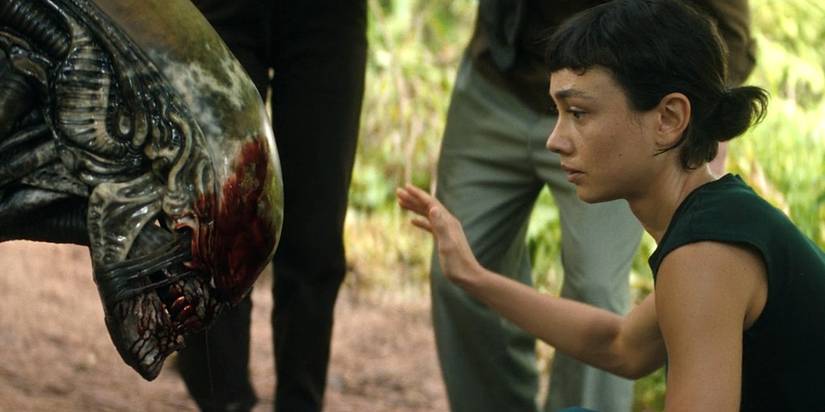 Wendy (Sydney Chandler) petting a Xenomorph with blood on its maw in Alien: Earth season 1, episode 7