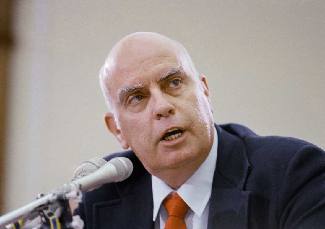 Wearing a suit and seated in front of a microphone, Morton Thiokol engineer Roger Boisjoly — appearing before the House Committee on Science and Technology on June 17, 1986 — details the objections he had to the launch of space shuttle Challenger when he learned of freezing temperatures at Kennedy Space Center.