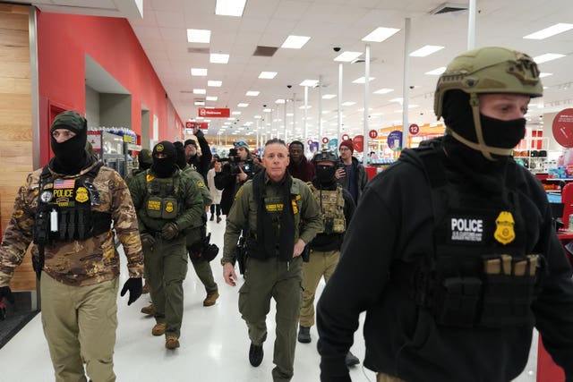 US Border Patrol commander Gregory Bovino leading other Ice officers through a Target store in St Paul, Minnesota