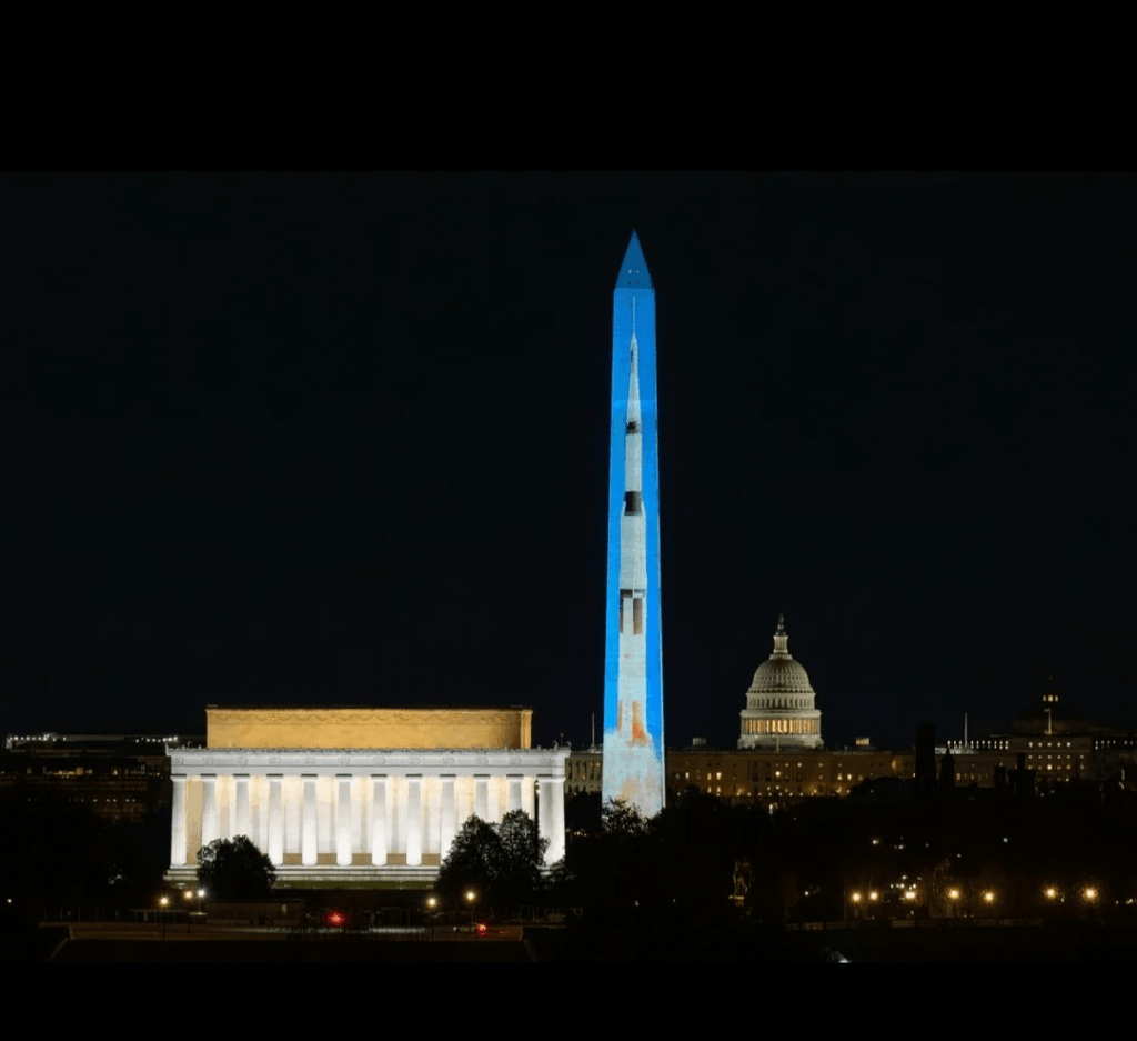 NASA's Saturn V Rocket are projected onto the Washington Monument