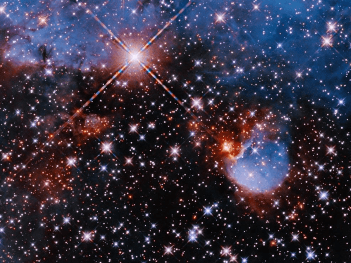 Bright stars against the black of space, surrounded by a brightly shining star and nebula system.