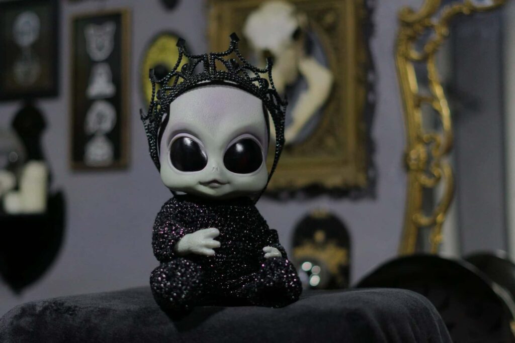 1. Cute black skeleton doll with a beaded crown, Halloween decoration, spooky style, dark theme.