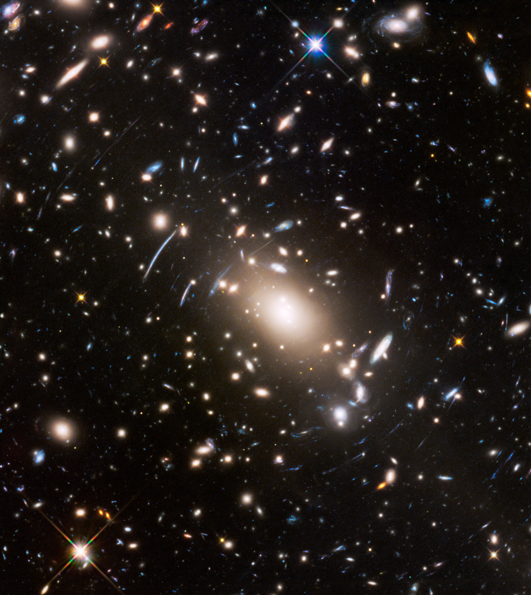 Image shows a dense cluster of distant galaxies in deep space, with light from some galaxies appearing stretched due to gravitational lensing—a phenomenon the JWST reveals as it unlocks secrets of our universe.