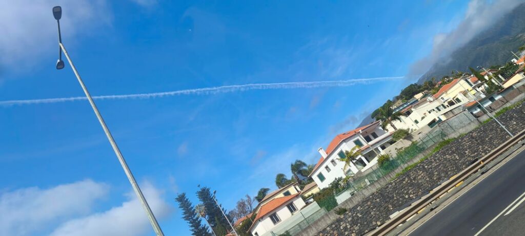 Small orb near plane trail Funchal 30/01