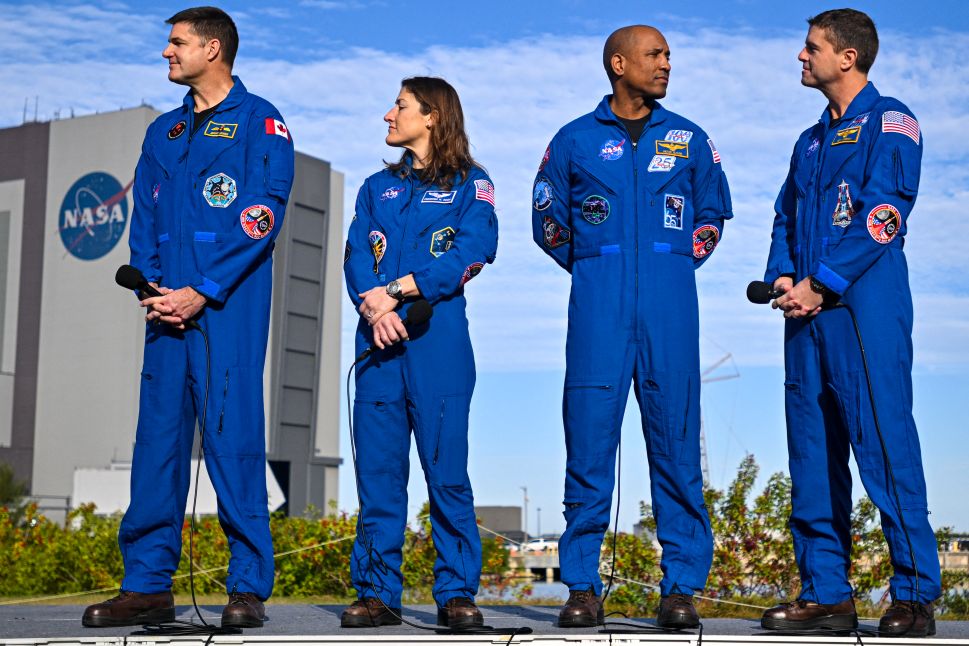 Astronauts Jeremy Hansen, Christina Koch, Victor Glover and Reid Wiseman stand together during the rollout of NASA’s Space Launch System rocket with the Orion crew capsule.