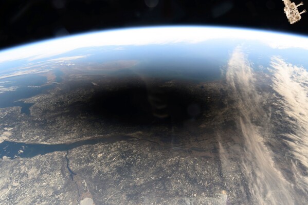 CORRECTS MONTH FILE - This photo provided by NASA shows the Moon's shadow covering portions of Canada and the U.S. during a total solar eclipse as seen from the International Space Station, on Monday, April 8, 2024. (NASA via AP, File)