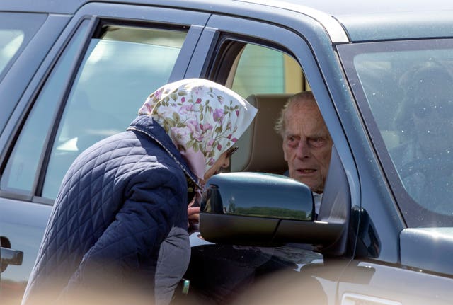 Queen Elizabeth II talking to the Duke of Edinburgh during the Royal Windsor Horse Show