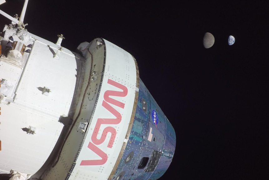 The orion spacecraft, with the moon, and Earth in the background.