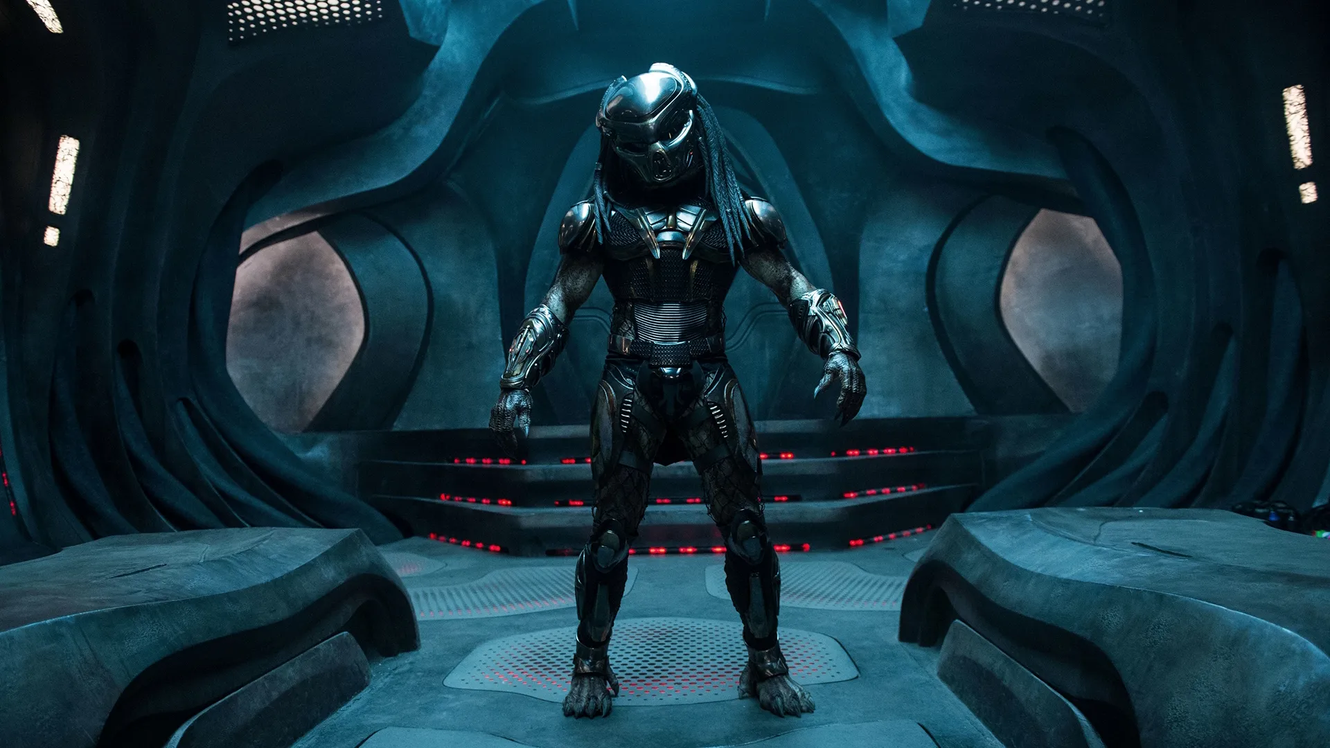 The Predator (Brian A. Prince) standing inside a futuristic sci-fi room