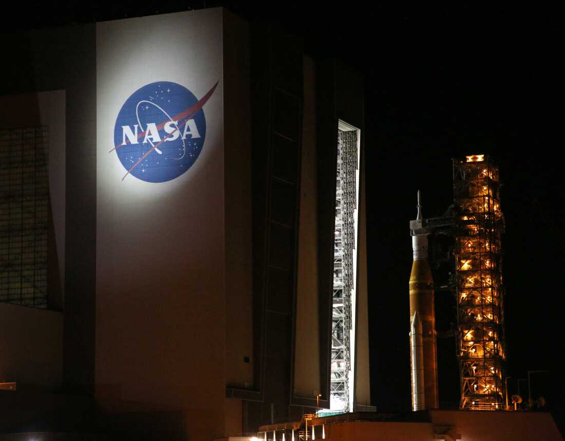 The mobile launcher containing the Artemis II Space Launch System rocket and Orion spacecraft arrives at the Vehicle Assembly Building after a rollback that lasted over ten hours at the Kennedy Space Center in Cape Canaveral, Florida, on February 25, 2026. NASA teams detected issues with the helium flow and removed the rocket from the launchpad.