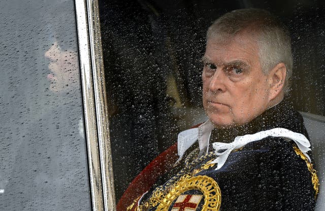 Prince Andrew looks out of a car window