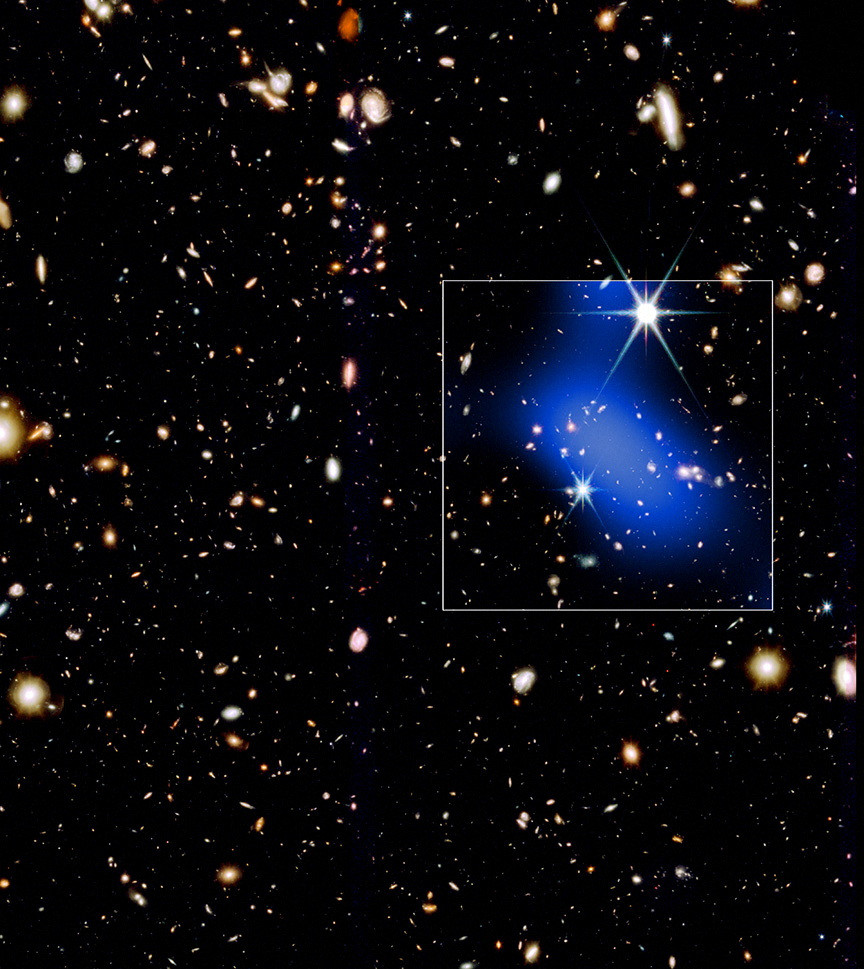 Galaxy cluster observed forming surprisingly early in universe’s history – Science & Tech A developing galaxy cluster dating to about 1 billion years after the Big Bang is shown in this handout image released on Jan. 28, 2026. The white box marks the field of view of the Chandra X-ray Observatory data (blue) that is overlaid on an infrared image from the James Webb Space Telescope showing the location of galaxies.