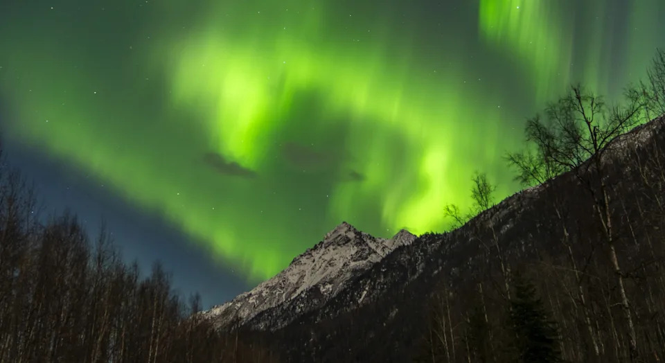 FILE: Northern lights (Aurora Borealis) illuminate the sky in Alaska's Eklutna Tailrace, United States on March 09, 2025.