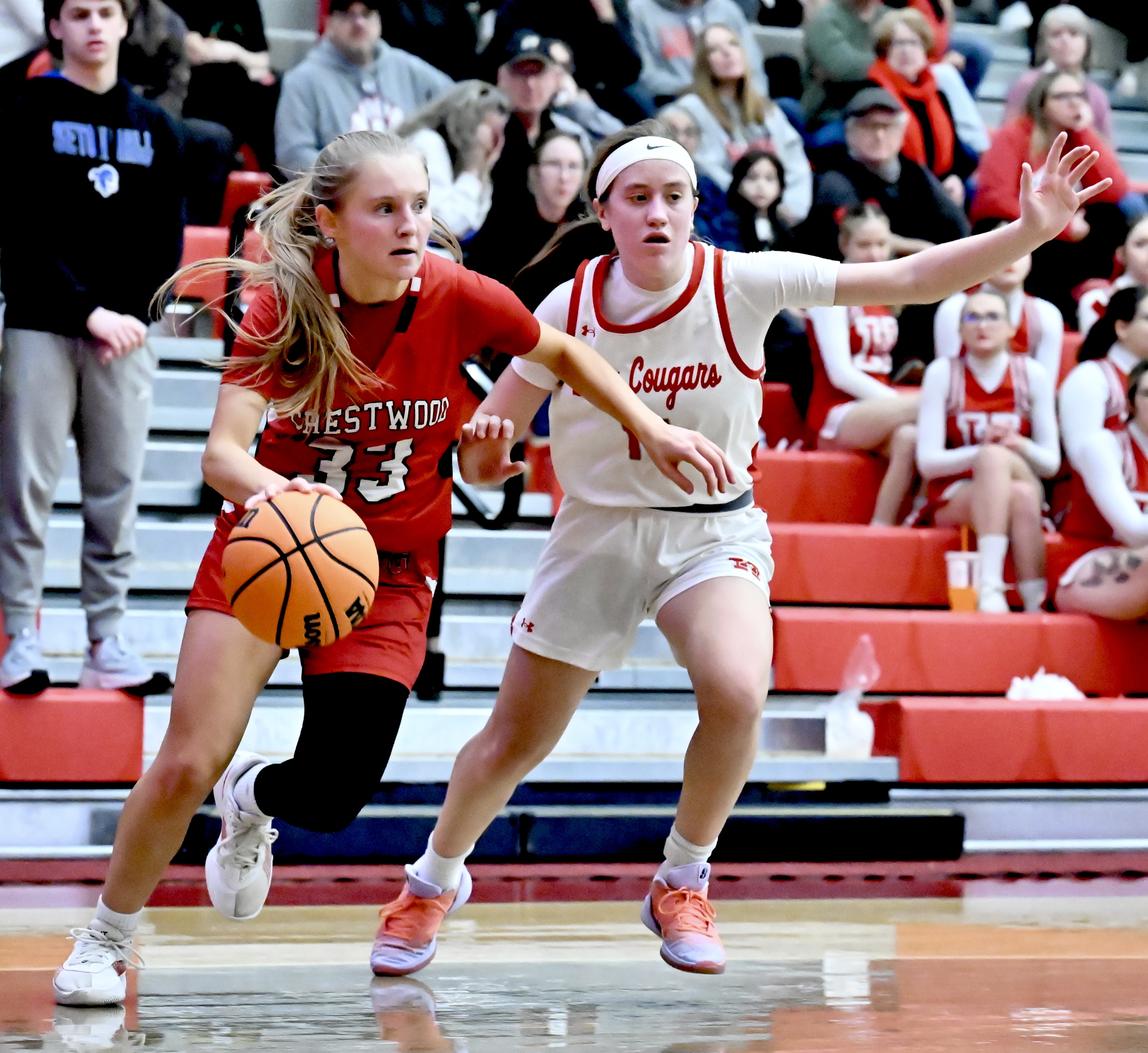 Crestwood’s Keira Dougherty (33) drives the baseline as Hazleton Area’s...