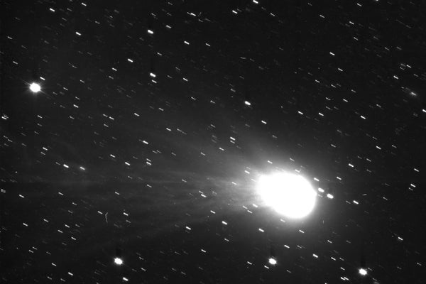 A photograph of a comet and its tail in space
