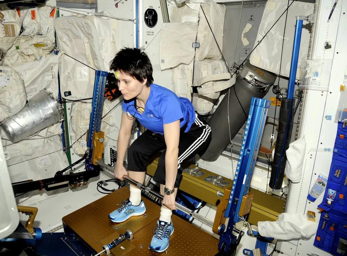 European Space Agency astronaut Samantha Cristoforetti uses the Advanced Resistive Exercise Device on the International Space Station, which enables astronauts to strengthen muscles in zero gravity. Credit: NASA/ESA