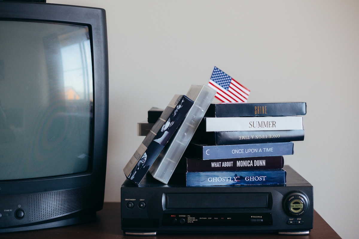 An old TV and a stack of VHS tapes