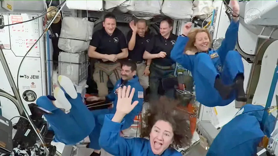 The Crew 12 fliers cavort aboard the International Space Station shortly after floating inside on Feb. 14, 2026. They joined station commander Sergey Kud-Sverchkov, back left in black shirt, NASA astronaut Chis Williams and cosmonaut Sergey Mikaev, both wearing black shirts. The Crew 12 astronauts, from left to right, are cosmonaut Andrey Fedyaev (upside down), Jack Hathaway, Jessica Meir and French astronaut Sophie Adenot at the far right. / Credit: NASA
