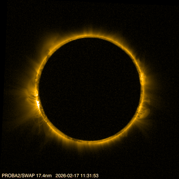 The sun's ring, shown in high resolution, peeks from behind a dark circle